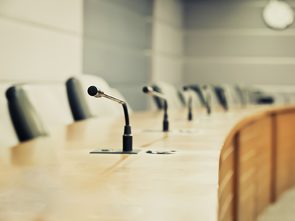 Professional meeting room with microphones on tables